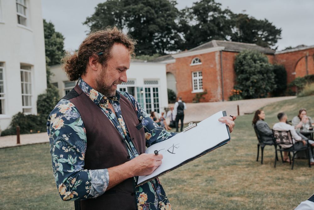Caricaturist from Sensible Pencil drawing wedding guests outdoors