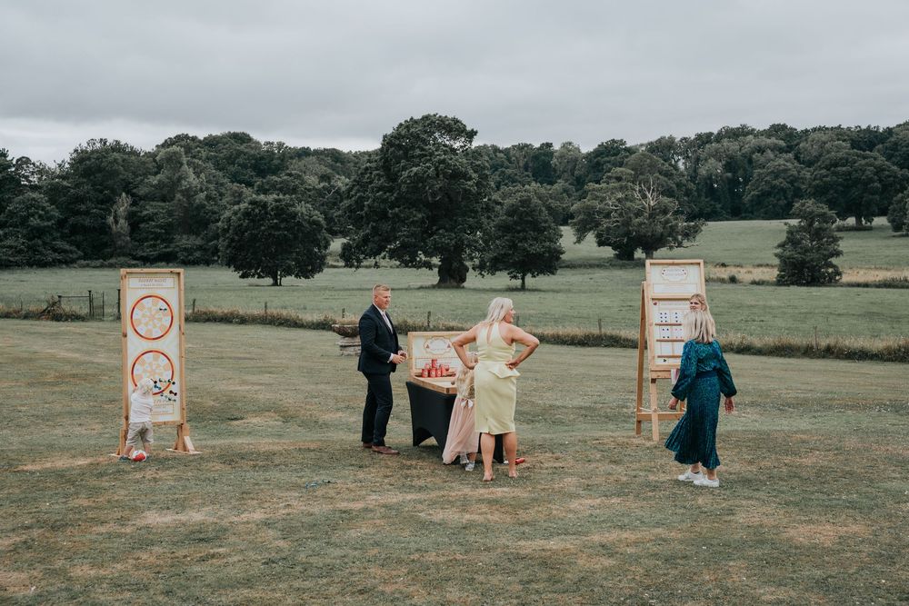 Guests playing garden games at Rockbeare Manor summer wedding