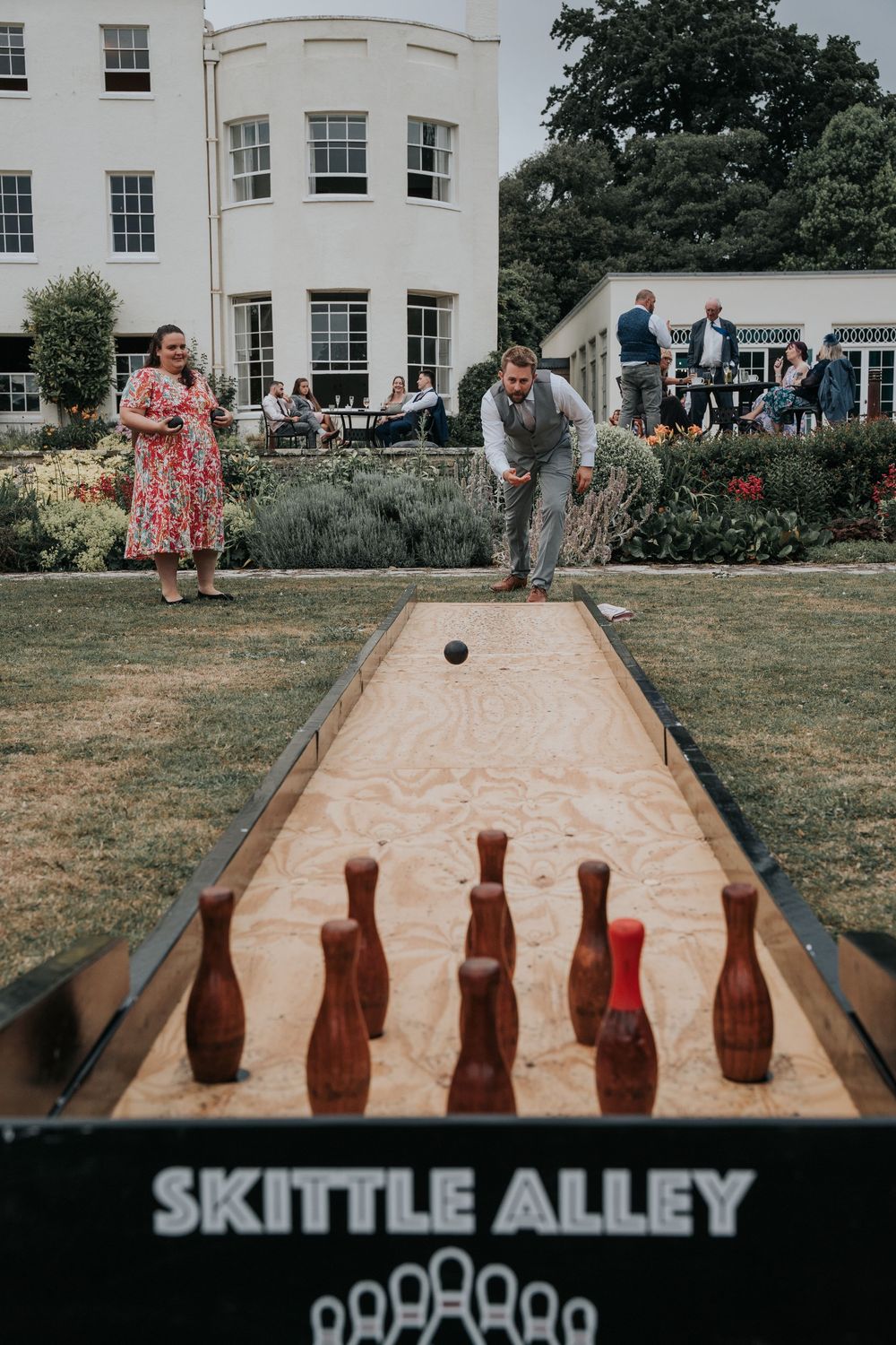 Guests playing garden games at Rockbeare Manor summer wedding