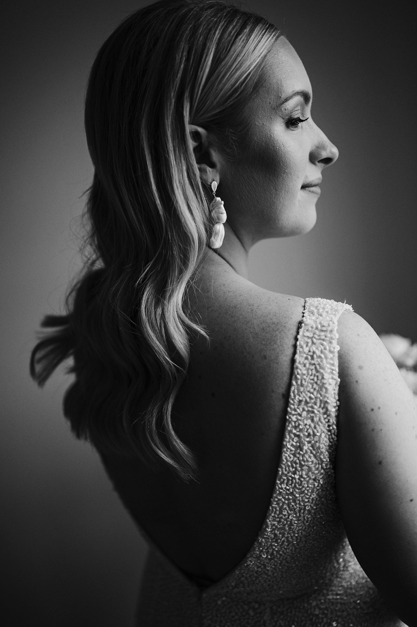 Dramatic black and white profile shots highlighting beaded wedding dress details.