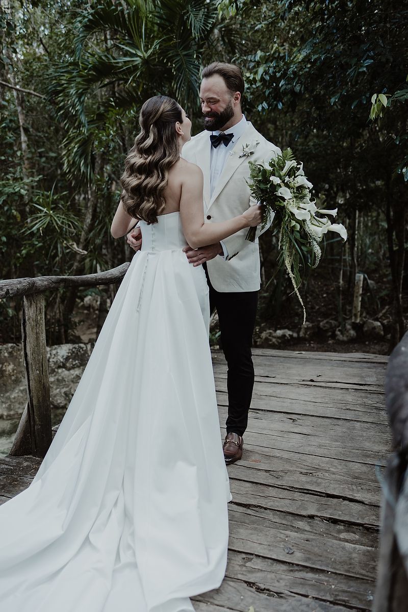 Bride and groom sharing first look on bridge at Kuha Casa del Agua, elegant wedding details in Mexico.