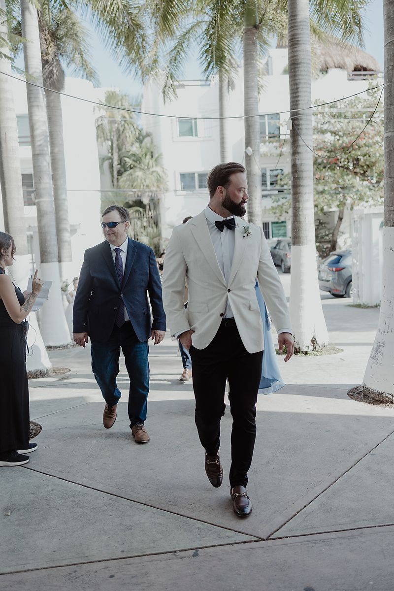Groom walking into church entrance at Parroquia de Nuestra Señora de Guadalupe, wedding photographer in Mexico.