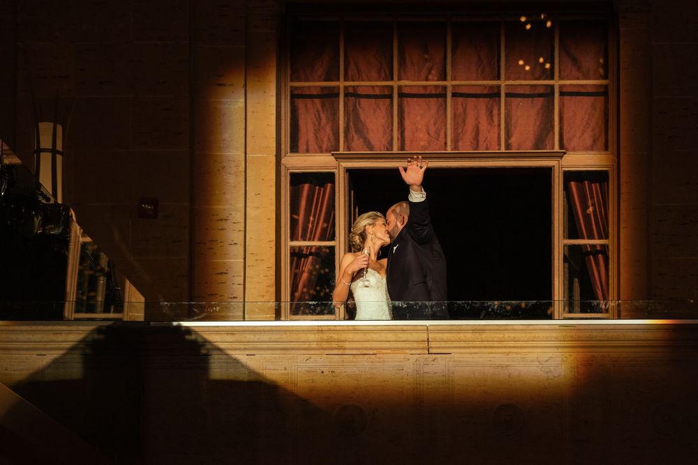 Dramatic lighting illuminates a wedding reception scene in an elegant venue at Union Trust in Philadelphia.