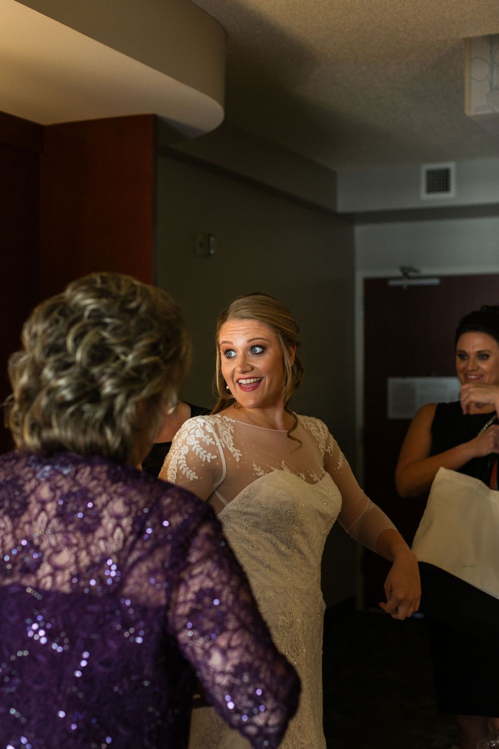 A celebratory moment during wedding preparations in an indoor setting.