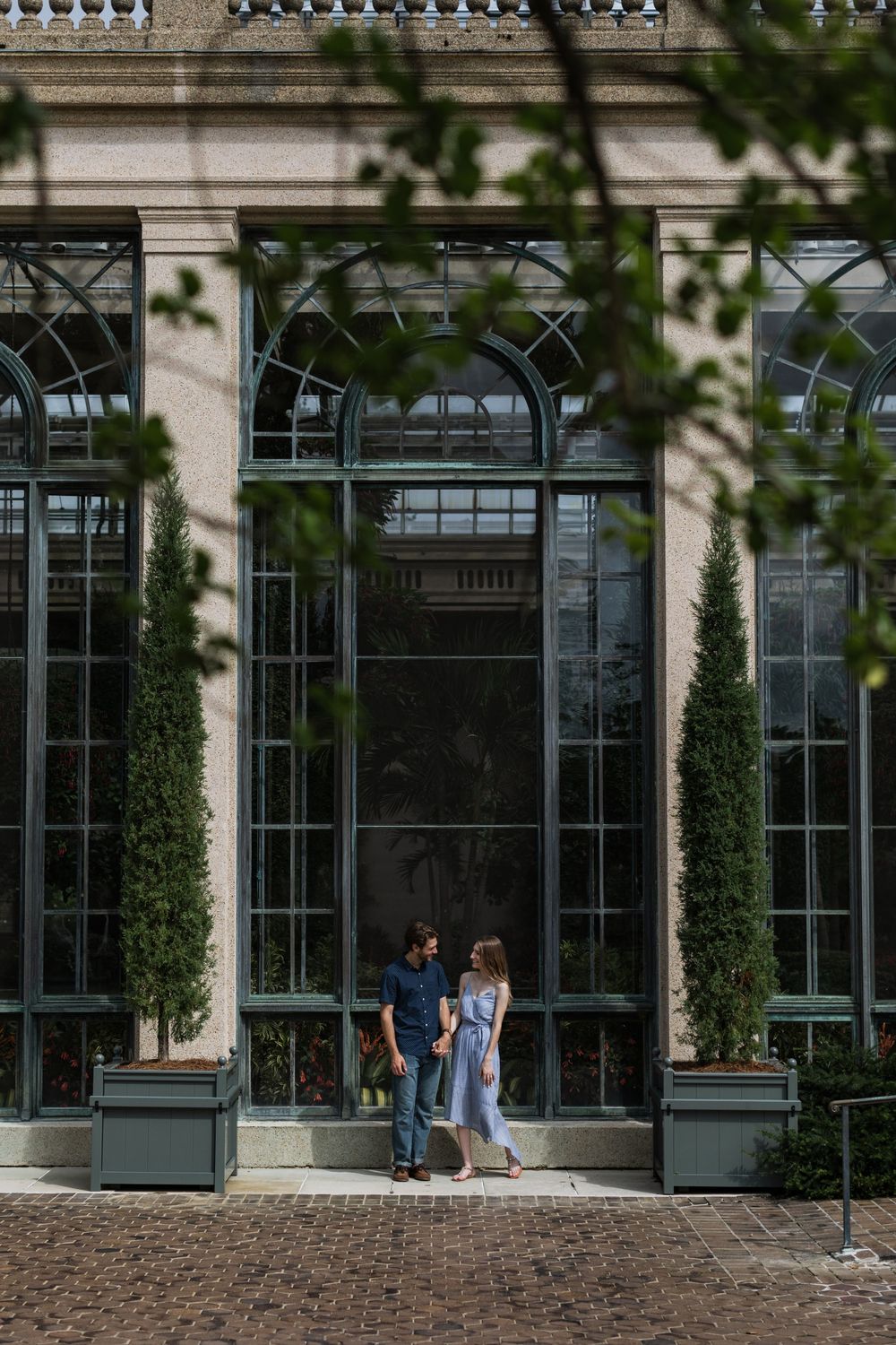 Historic conservatory building exterior with ornate windows and climbing vines at Longwood Gardens.