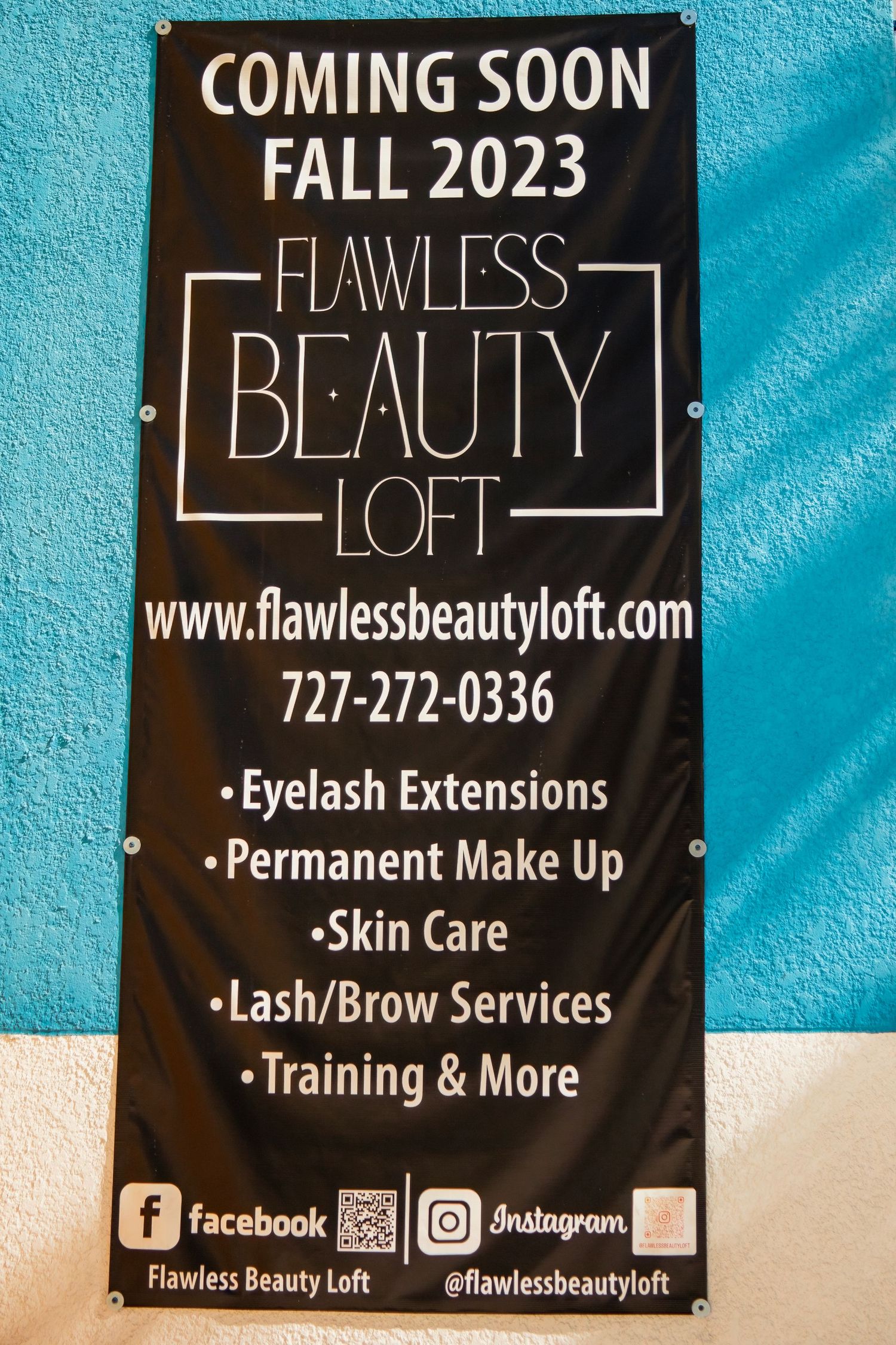 Black business signage on turquoise wall advertising beauty services and contact information.