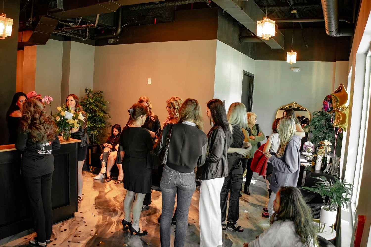 Celebration event in a modern interior space with guests mingling and refreshments.