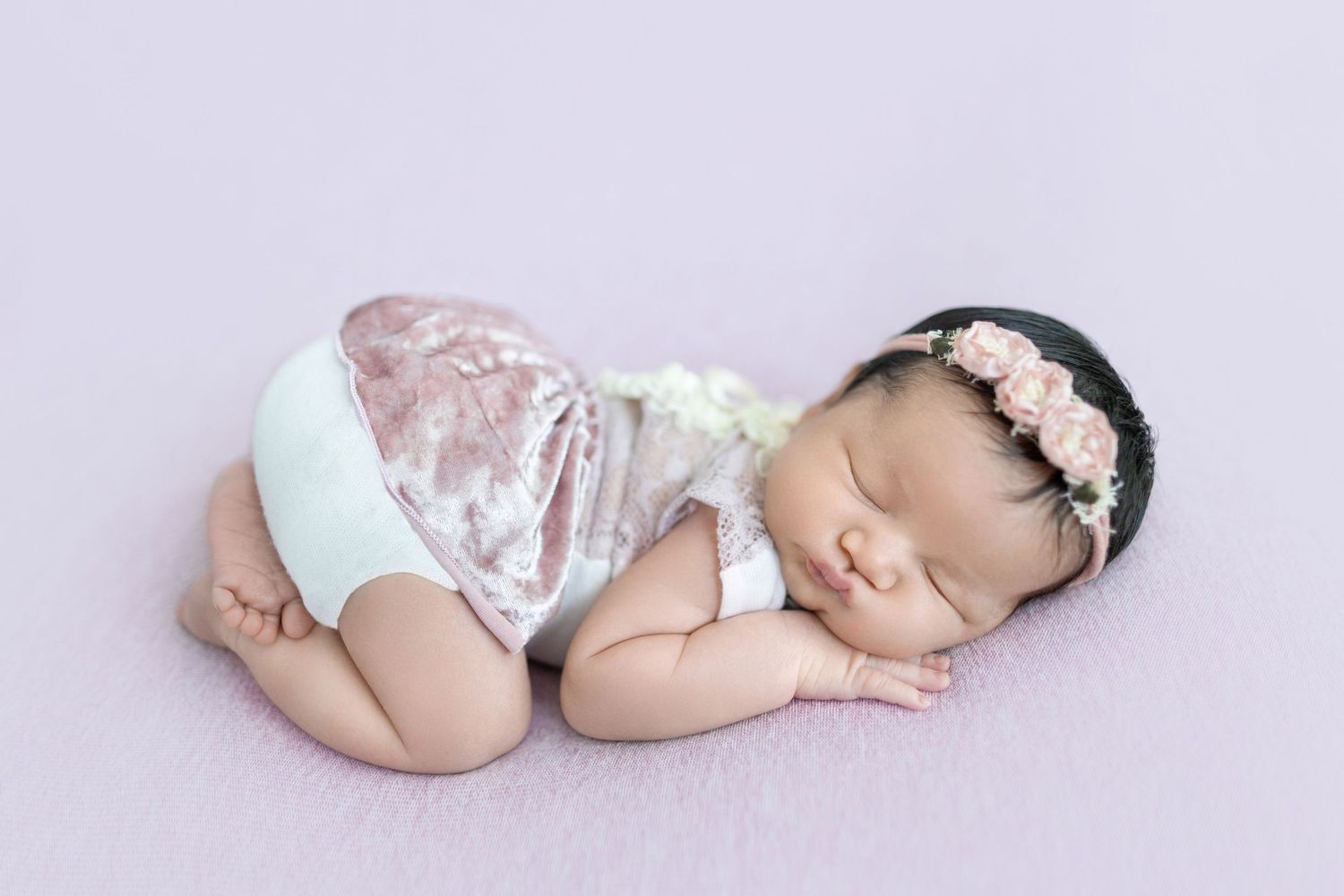 Sleeping newborn in velvet outfit with lace headband during professional photography session. Photos by Tampa Photographer DigitalMyst Photo
