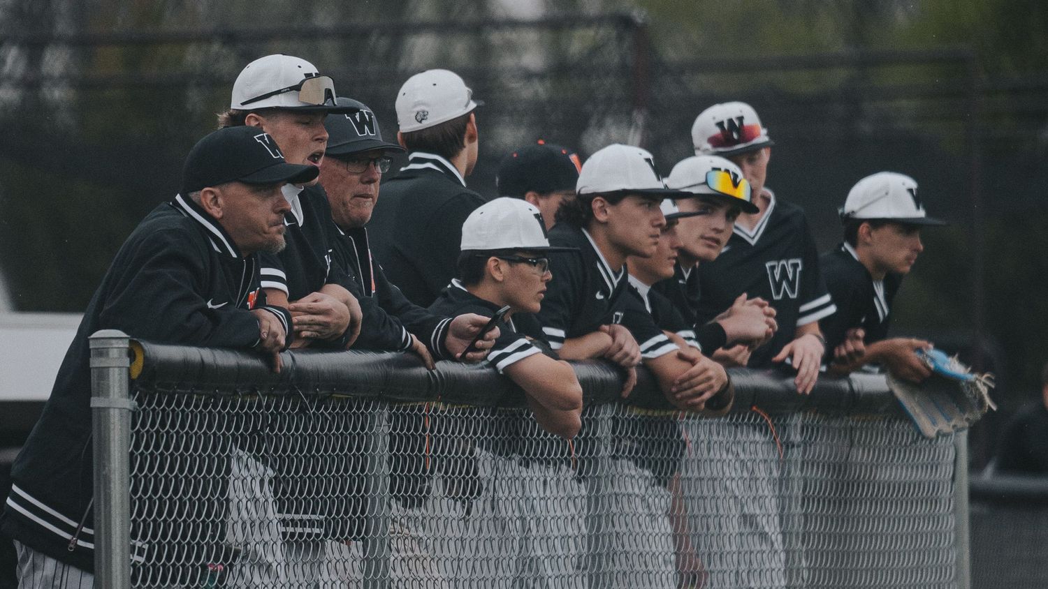 Sports Photography of an baseball team lined up in the dugout during a game - Warsaw, Indiana