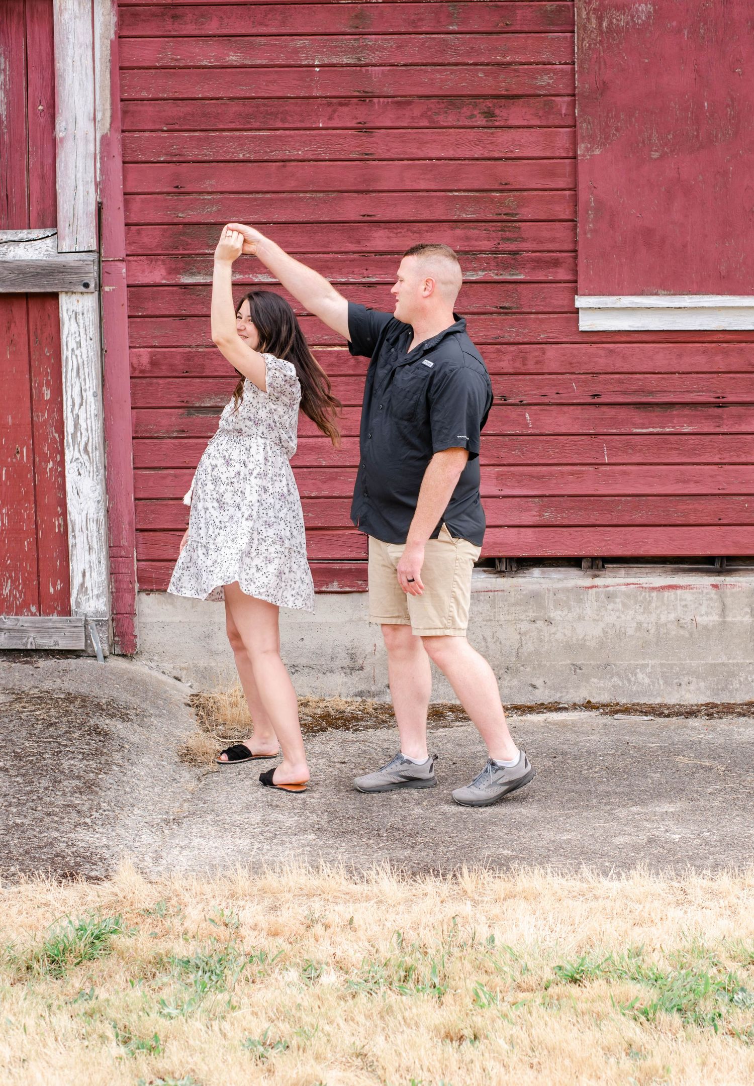 Playful sequence showing a couple interacting against a rustic red barn wall.