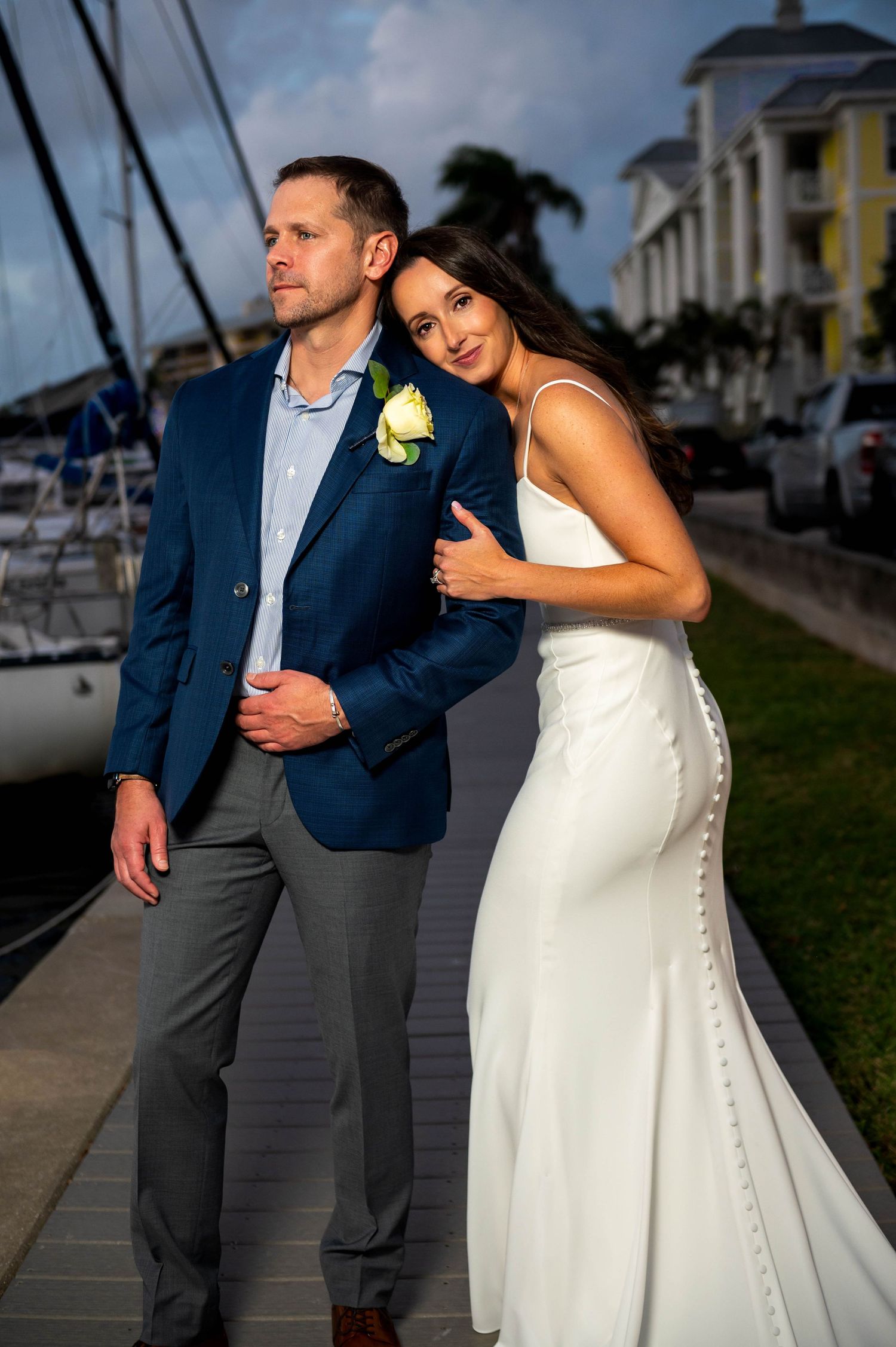 Bride and groom smiling under palm trees at Jupiter Beach, captured by expert Jupiter wedding photographers.