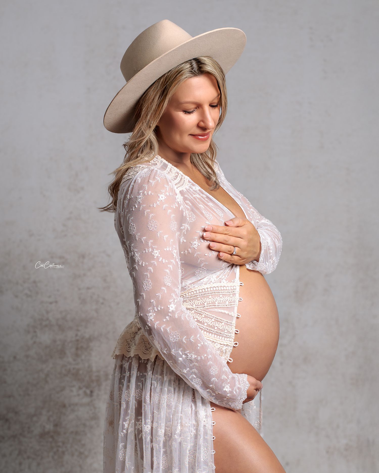 Chic pregnant client in a lace cream couture gown in a Sydney studio.