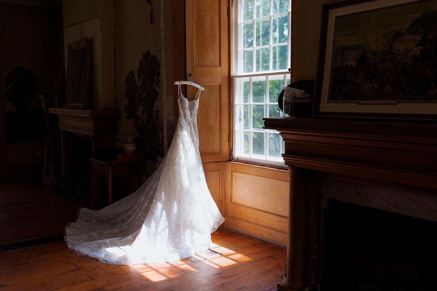 Sunlight streams through window onto wedding dress in vintage room.