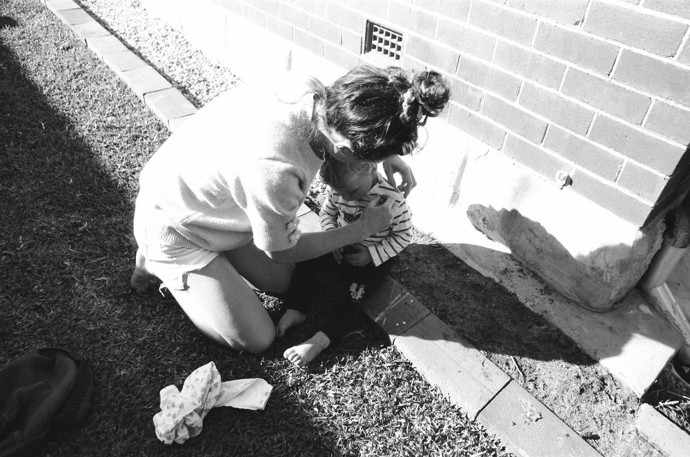 Authentic family photos of a Perth family with twins, captured during a playful backyard session.