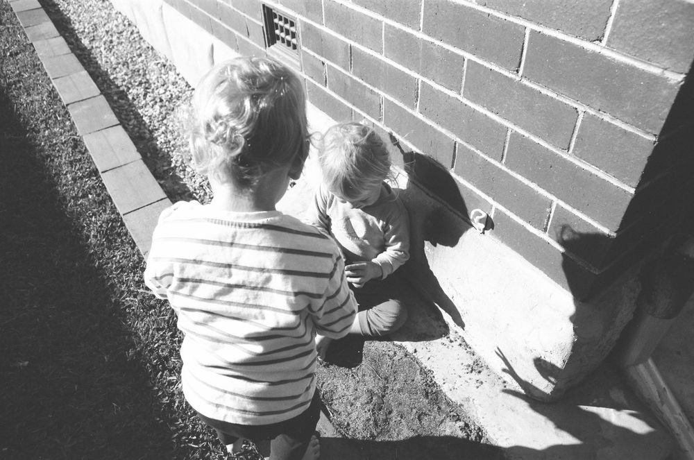 Warm family lifestyle photos in Perth, featuring twins, mum, and dad in a natural home setting.