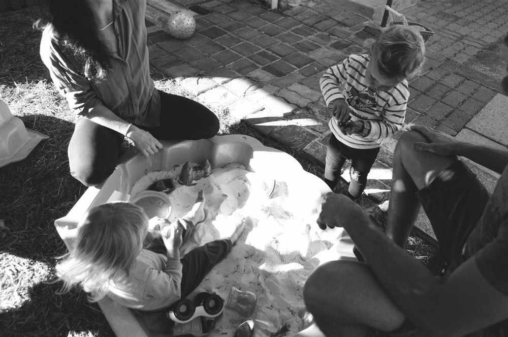 In-home family photoshoot in Perth, featuring playful moments with parents and twins.