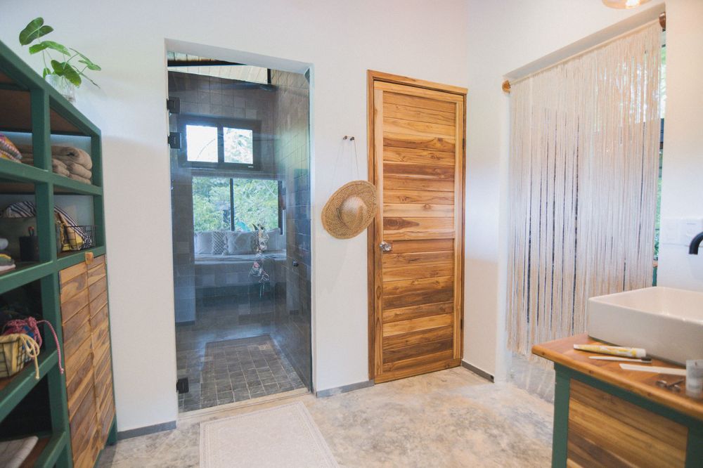 Interior hallway with wooden doors and beige tile flooring in modern cabin.