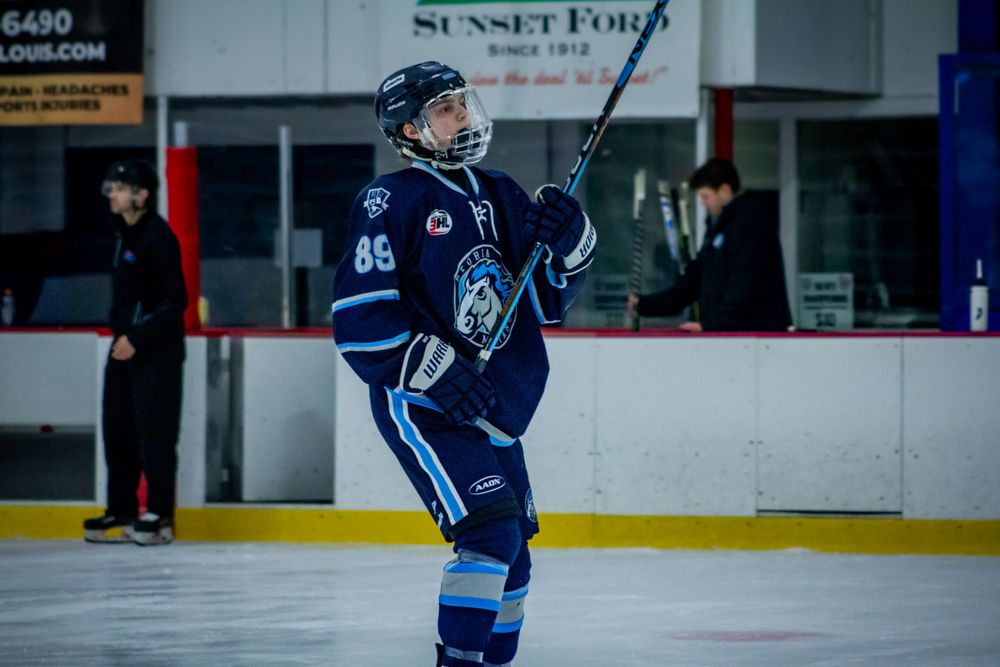 Peoria Mustangs Hockey Player Anden Marceau looking stressed on the ice in between periods versus the Jr Blues at the Affton Ice Rink.