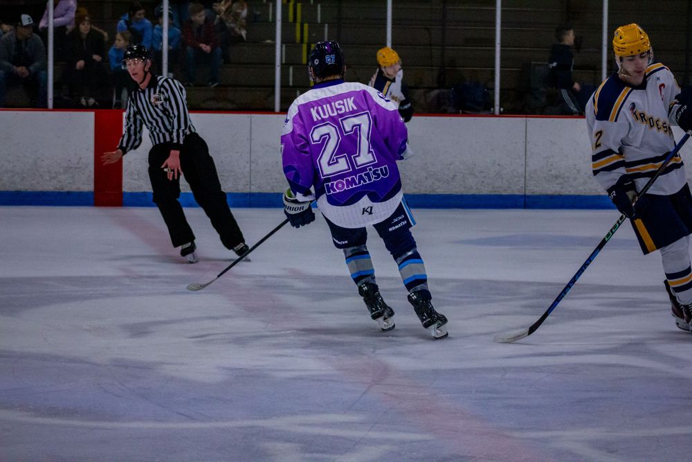 Peoria Mustangs player Robin Kuusik in purple number 27 jersey skating during gameplay.
