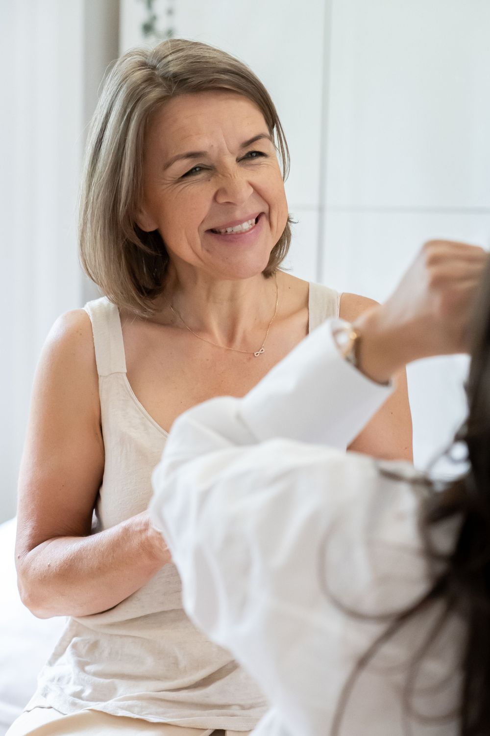 Warm interaction during professional hair care service in bright spa setting.