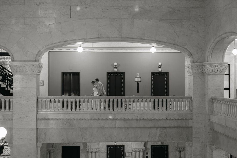 Interior architectural details of a historic building with arched ceilings, ornate moldings, and multiple doorways.