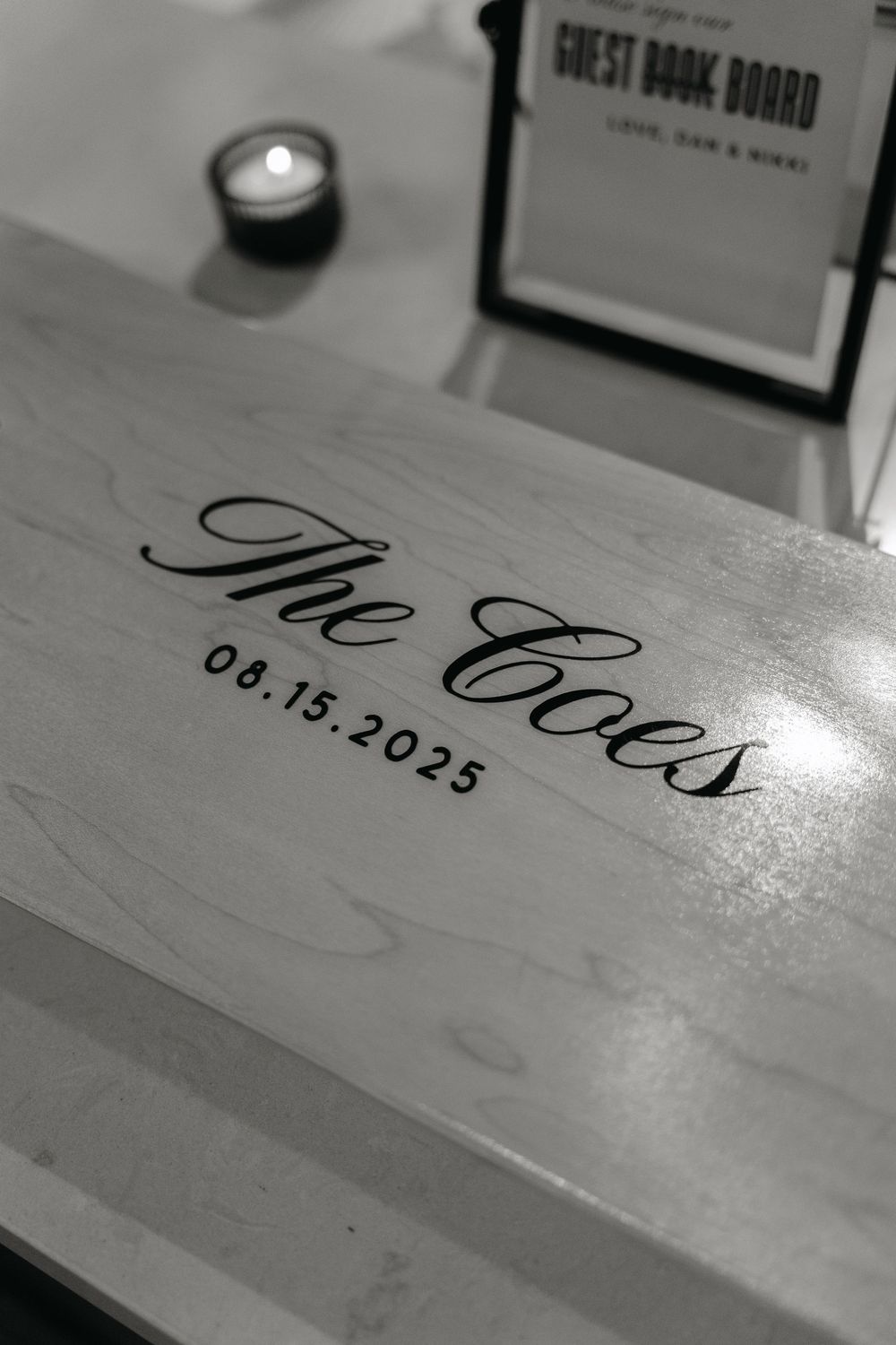 Close-up view of handwritten text on a white wooden surface showing elegant script writing.