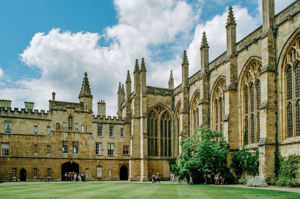 Gothic courtyard of Christ Church College with manicured lawn and medieval architecture.