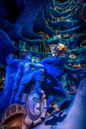 Inside Dr. Seuss Landing at Universal Studios, a whimsical blue-tinted scene shows winding staircases in a fantastical setting.