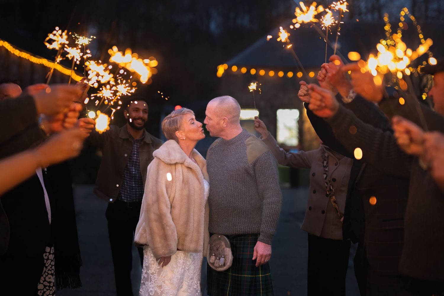 bride and groom kiss in sparkler tunnel at dalkeith country park, Edinburgh