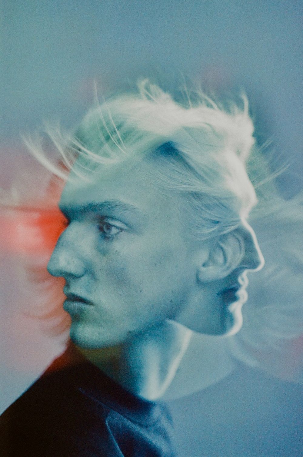 Ethereal double exposure portrait with dreamy blue tones.