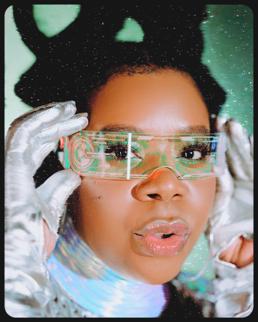 Fashion portrait showcasing holographic eyewear, white gloves, and dramatic lighting against a teal background.