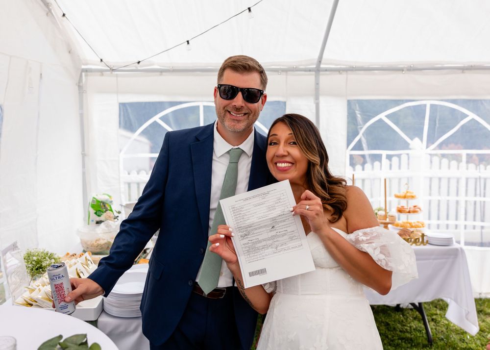Signing the marriage license at backyard garden wedding in Omaha, Nebraska. - BrightSide Photography