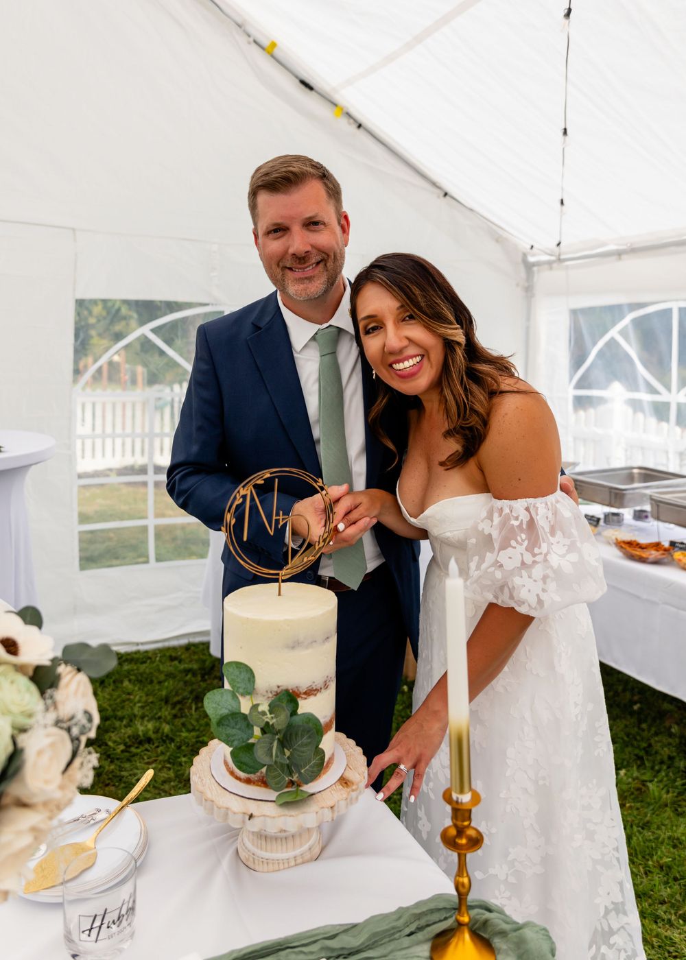 Cutting the wedding cake at backyard garden wedding in Omaha, Nebraska. - BrightSide Photography