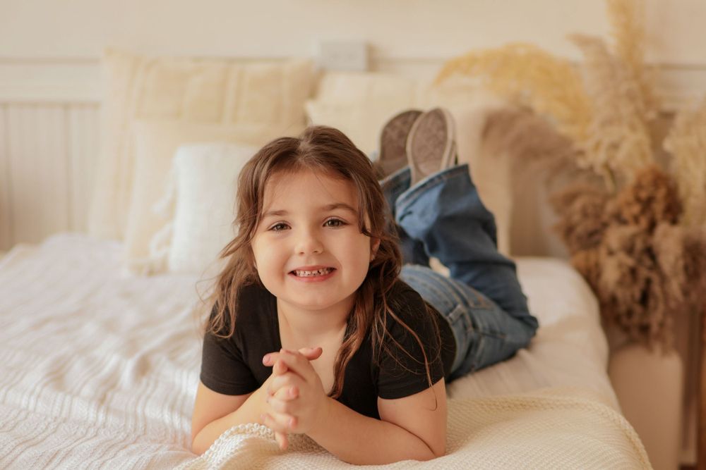 Lifestyle family photoshoot with neutral tones and pampas grass decor.