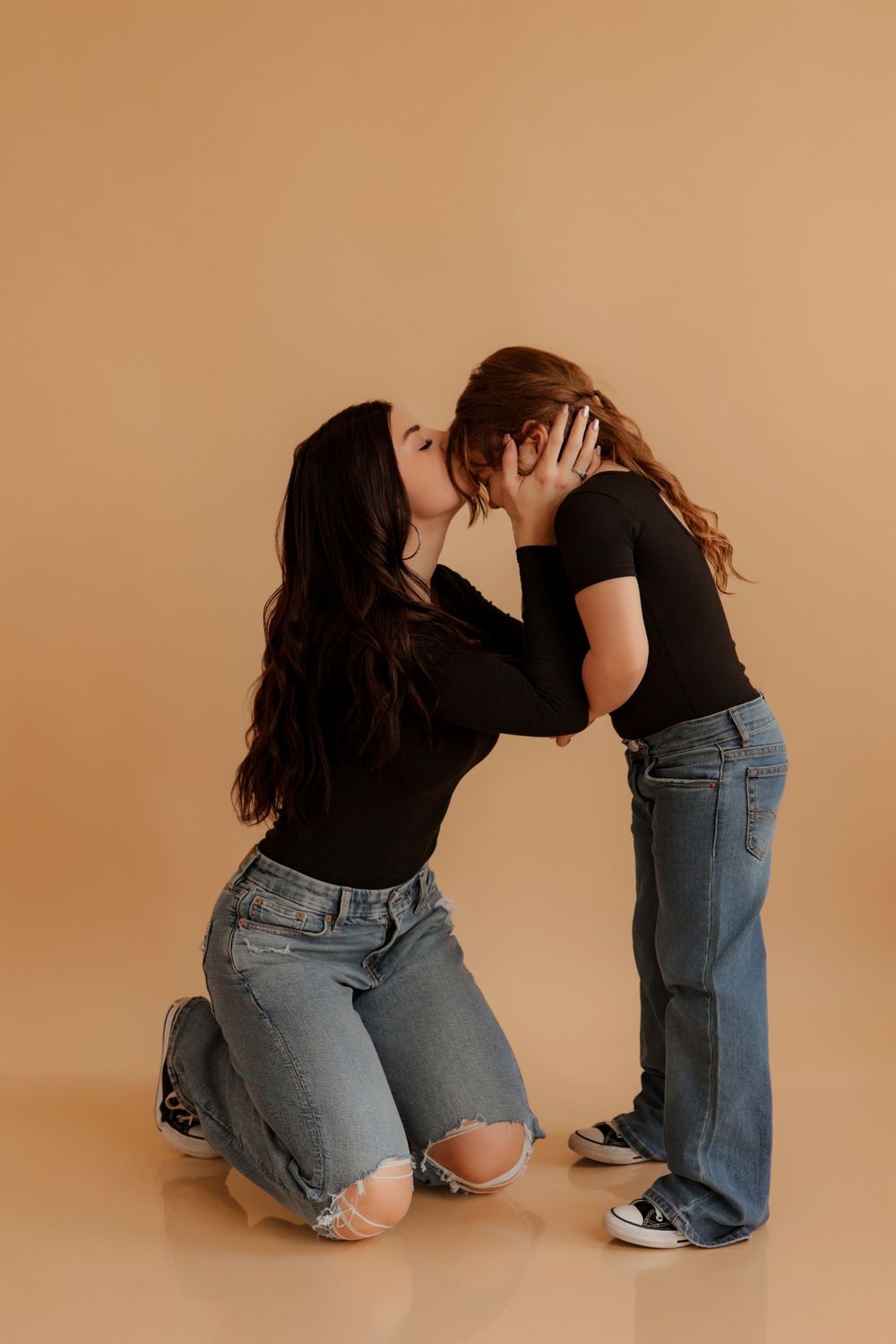 Candid moments of two people in denim sitting and interacting on a beige background.