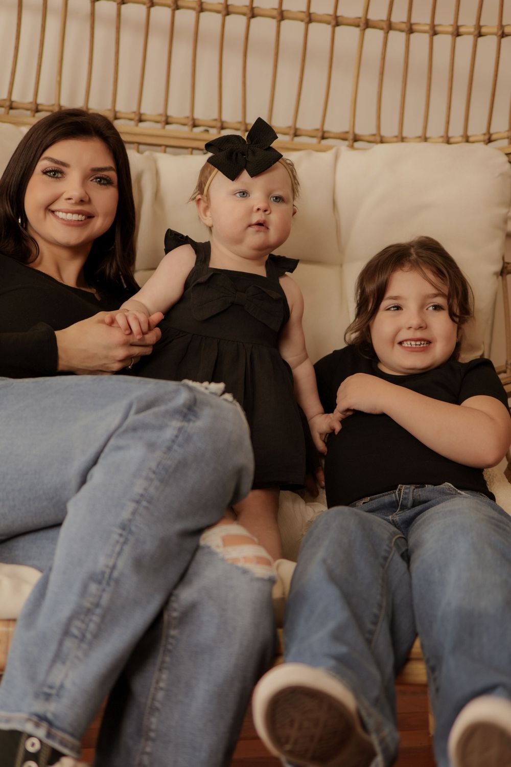 Relaxed lifestyle photos of people lounging on a white couch wearing casual denim and black clothing.