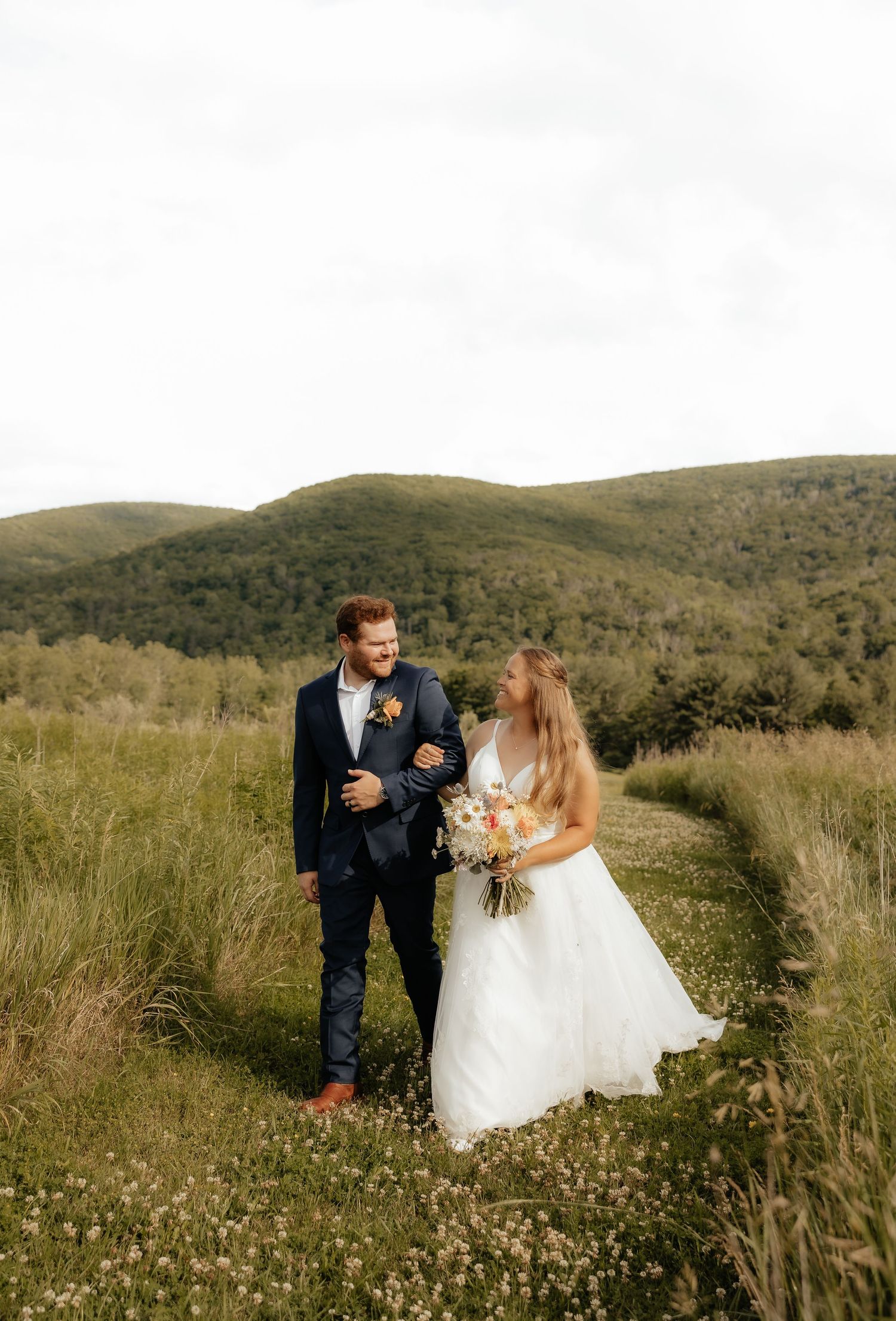 A winter proposal scene unfolds in the snow by a frozen lake surrounded by snow-covered trees.
