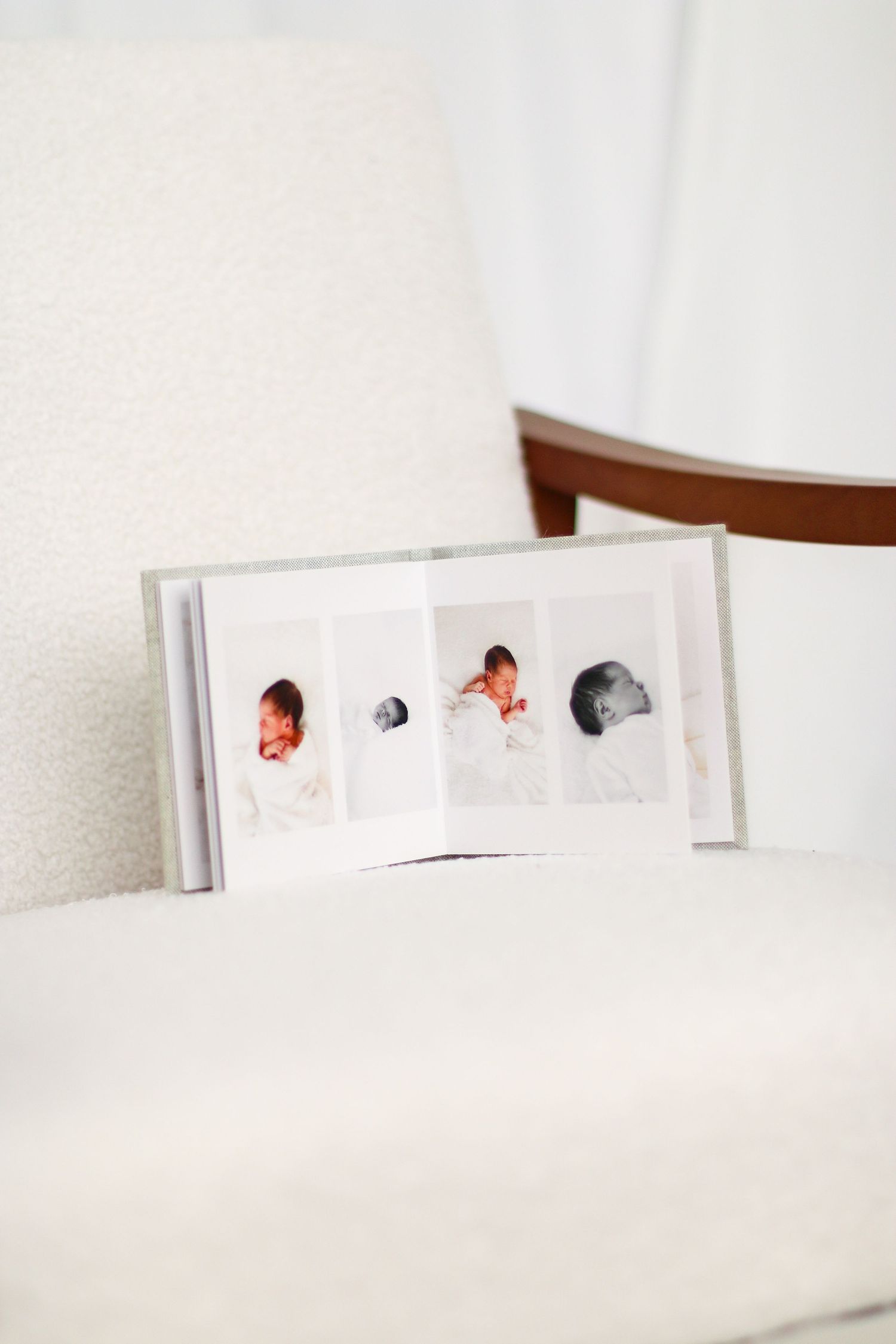 A minimalist white photo album with small square images arranged in a clean, modern design Nottingham family Photographer