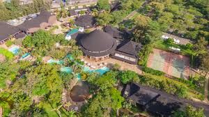 luxury garden wedding venue in Nairobi, captured by Nairobi Wedding Photographer, Bonnie Gichuru, showcasing lush greenery and flower arches