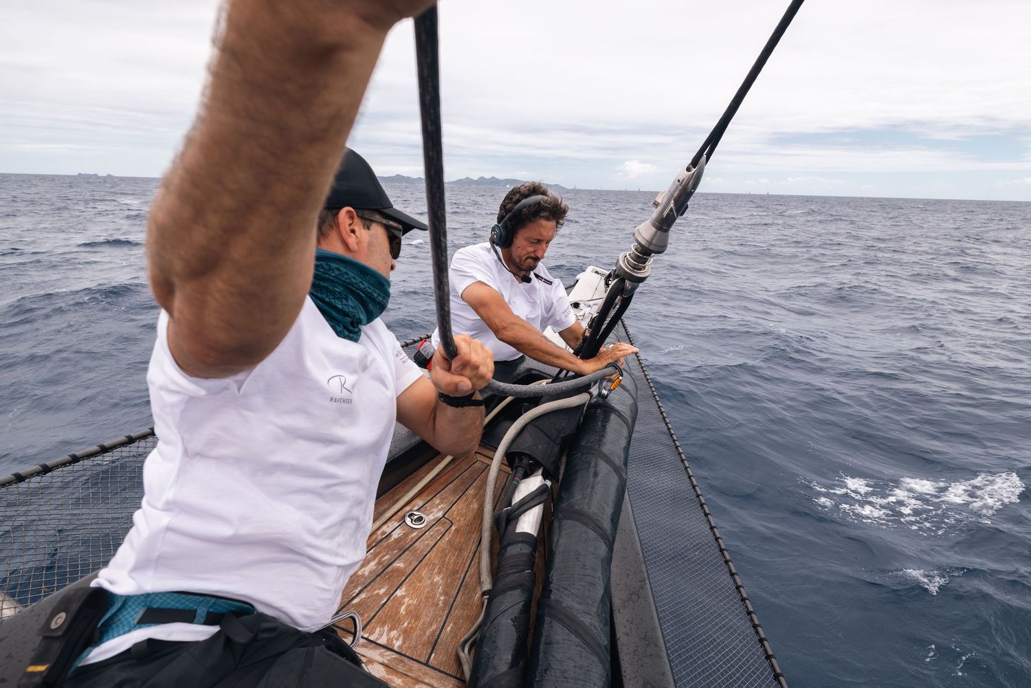 A series of action shots showing deep sea fishing with people reeling in catches from a boat on the ocean.