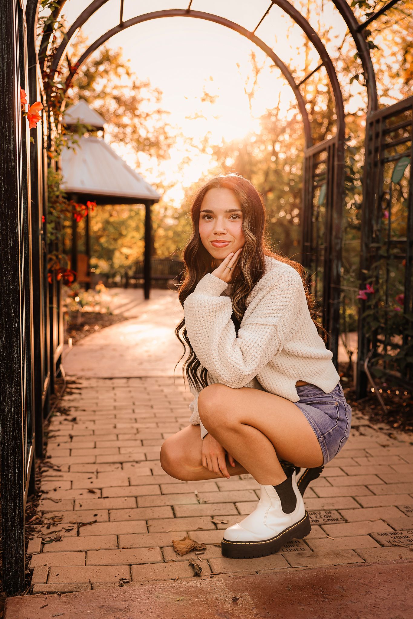 High school senior girl posing under archway in Springfield MO