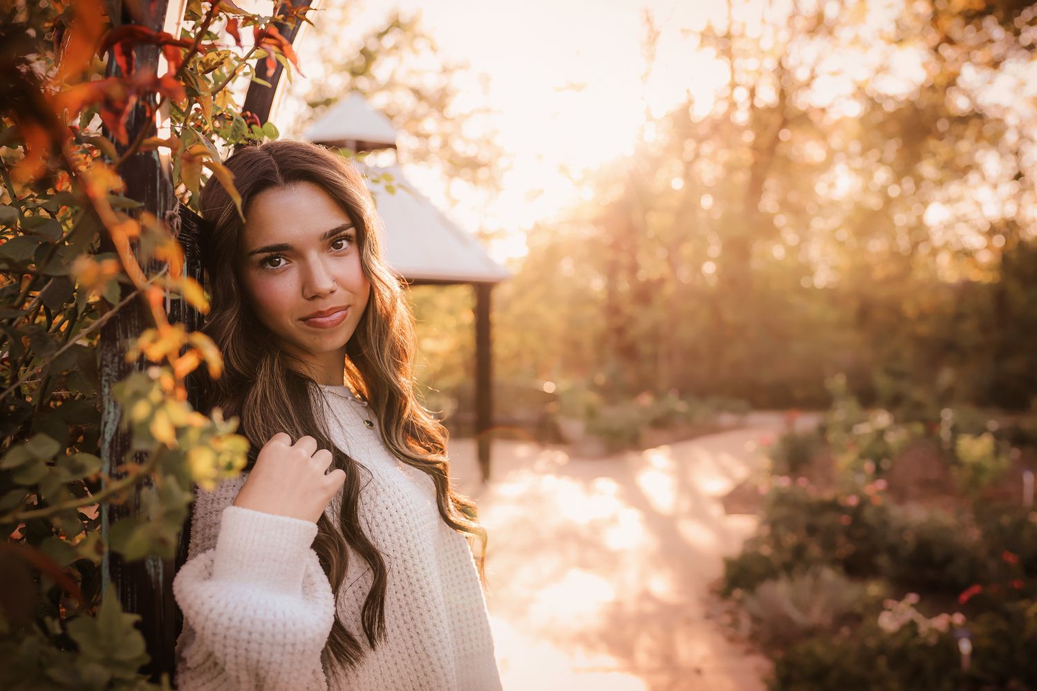 High school senior girl with sunset during fall time