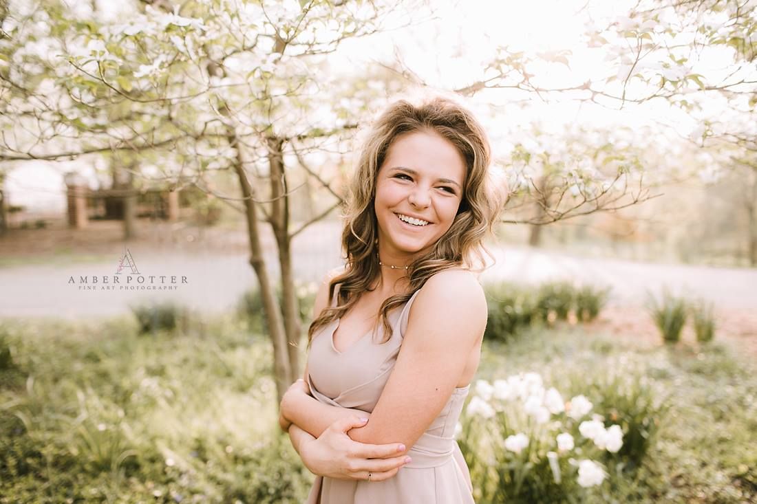 Senior girl in sundress surrounded by spring blossoms – Springfield MO senior photographer.