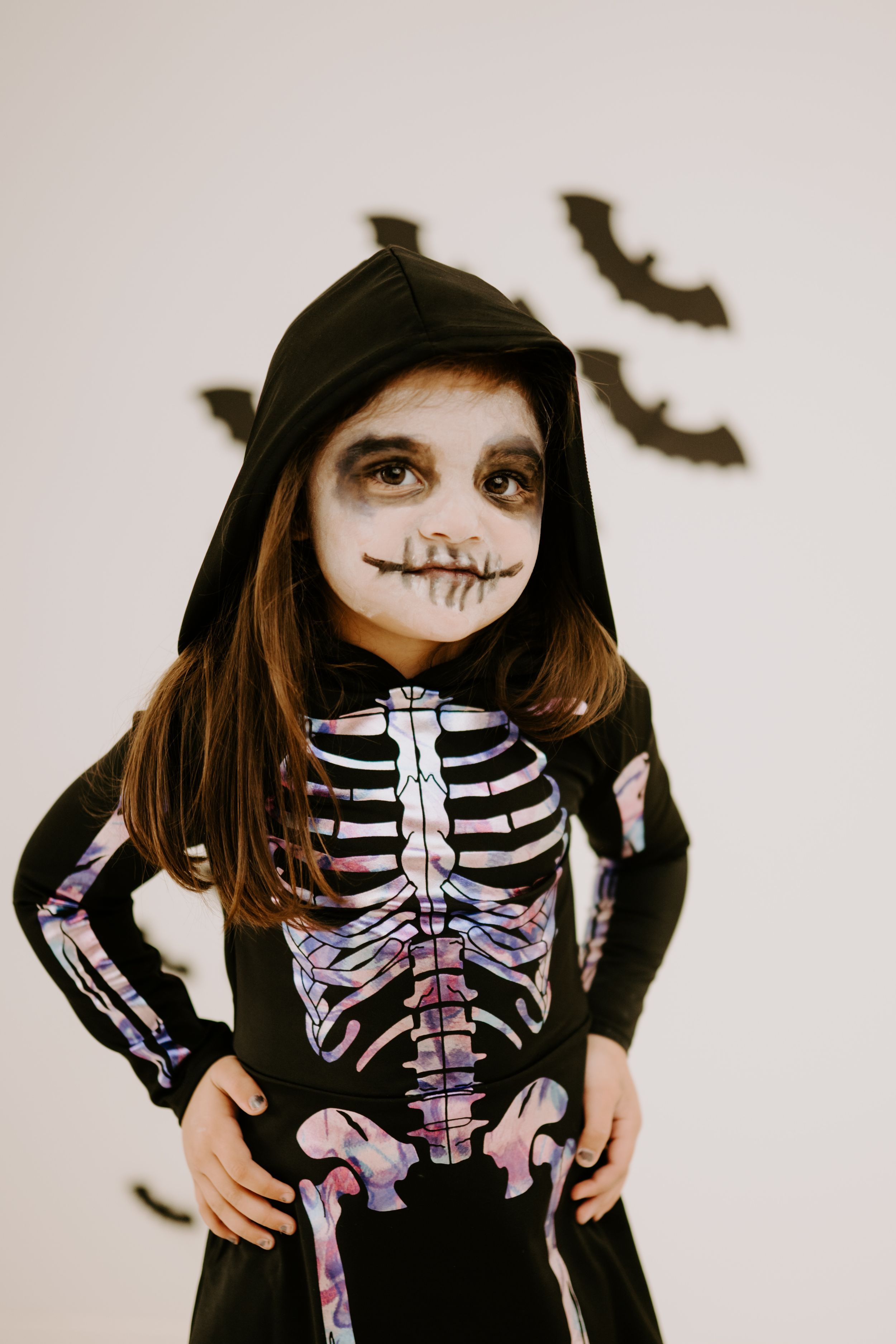 Close-up view of a skeleton costume with colorful ribcage design and face paint.