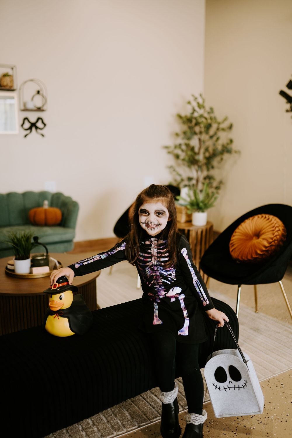 Halloween-themed indoor scene with skeleton decorations and festive orange accents.