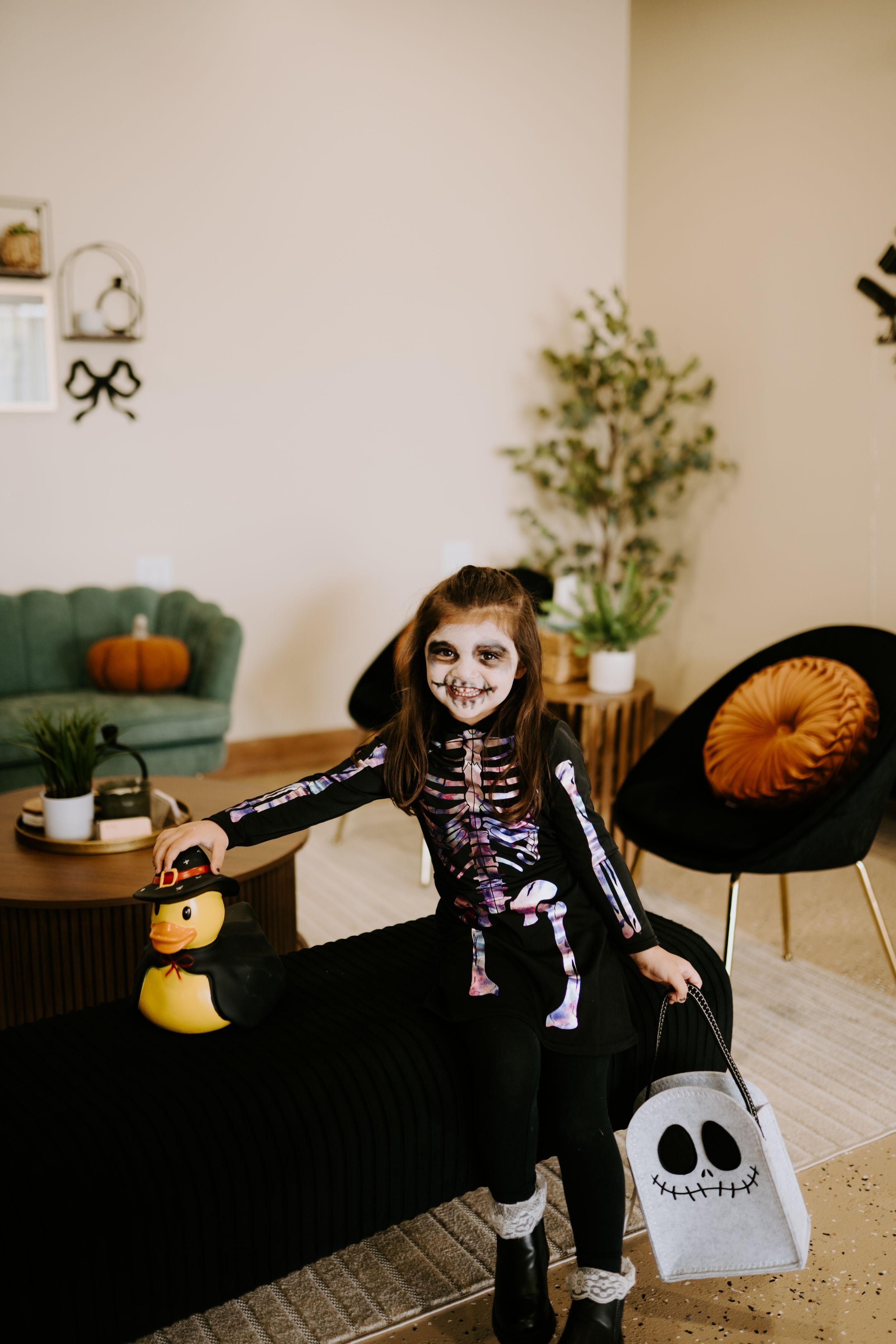 Halloween-themed indoor scene with skeleton decorations and festive orange accents.