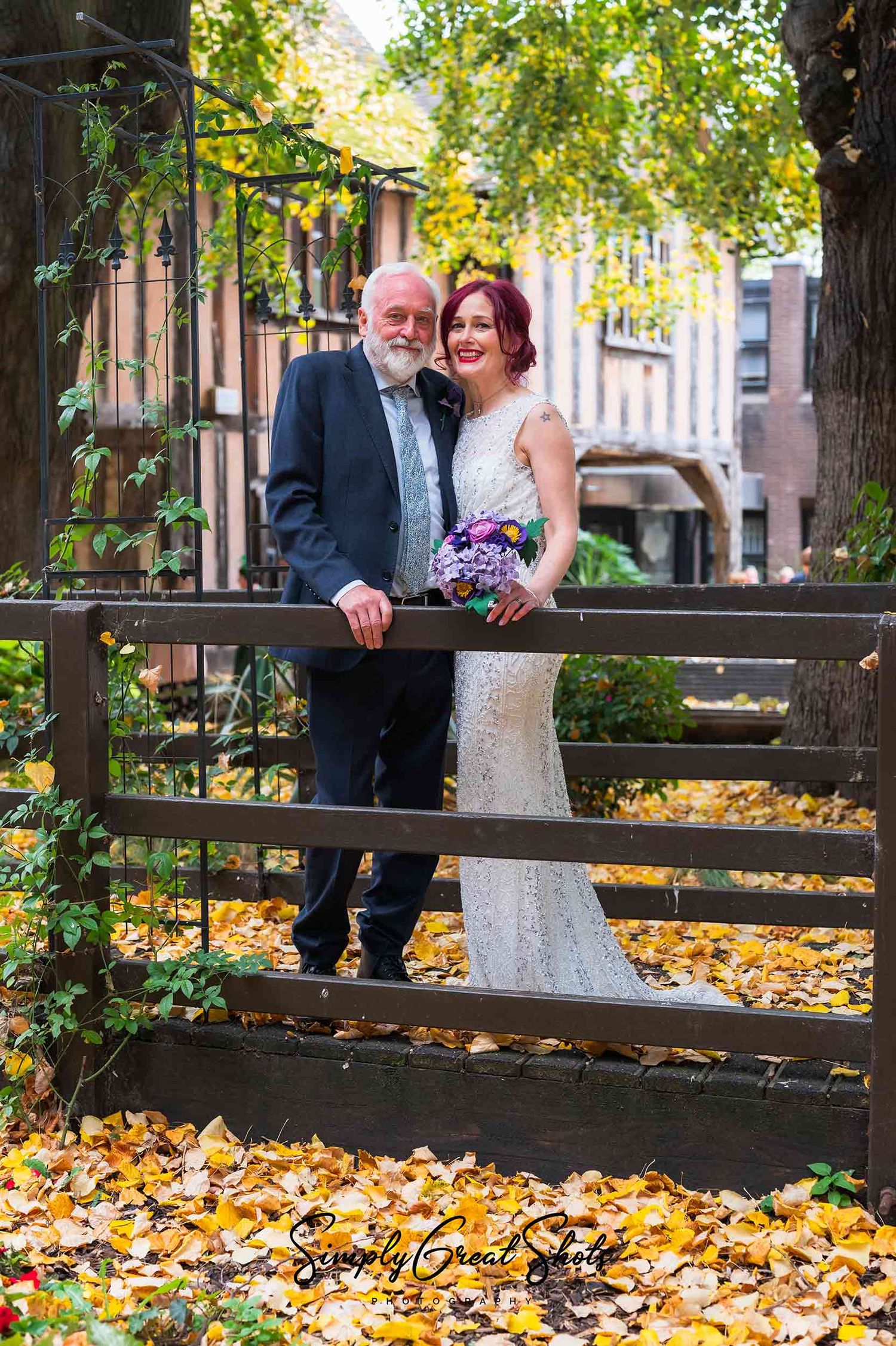 Coventry registry office photographer captures a bride and groom on the bridge surrounded by autumn leaves.