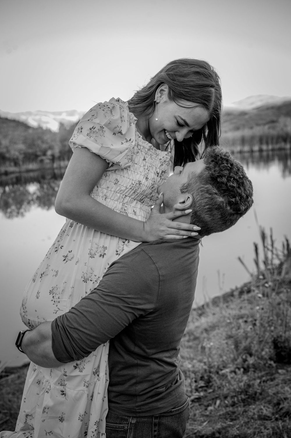 Black and white romantic portraits captured by lakeside during engagement session.