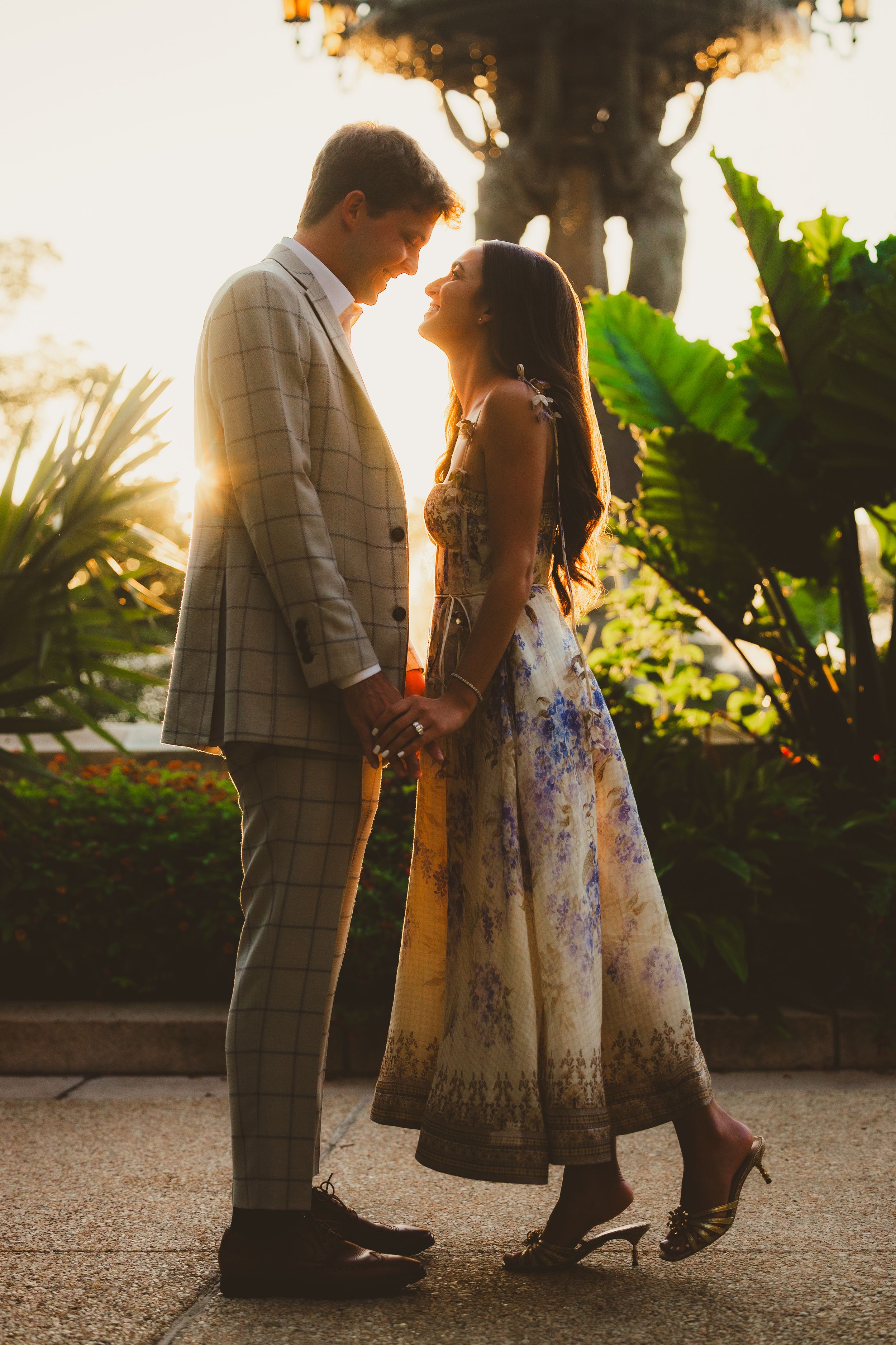 A romantic couple stands together in a Bartholdi Fountain garden at sunset, captured in a series of intimate moments.