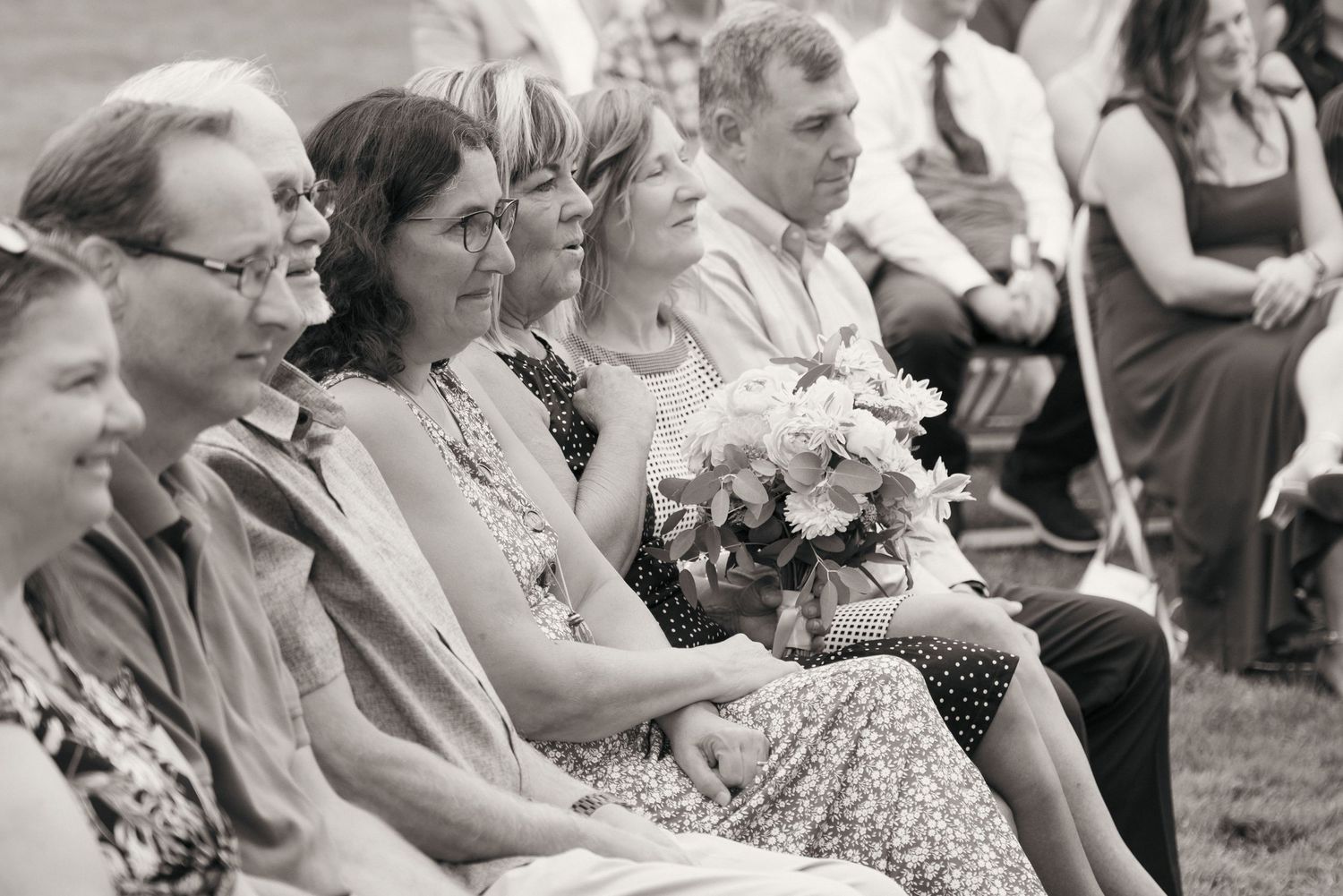 Family members observing a wedding ceremony at Clearwater Casino in Bainbridge WA. Captured by Savvy Photography.